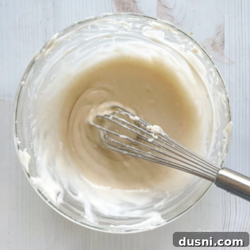 Baked donuts cooling on a wire rack, showing their soft texture and golden-brown color.