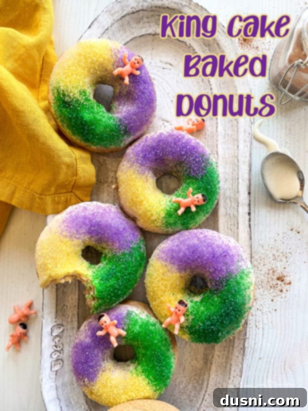 A vibrant close-up of King Cake donuts with purple, green, and gold sprinkles, creating a festive Mardi Gras atmosphere.