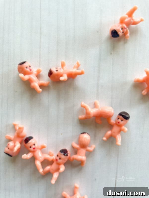 Hand dipping a baked donut into a bowl of vanilla cinnamon glaze.