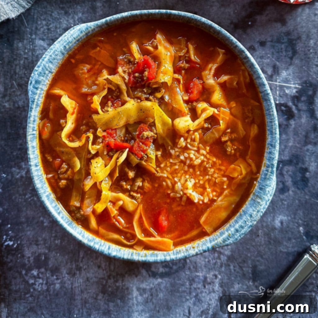 Close up of cabbage roll soup in a blue bowl