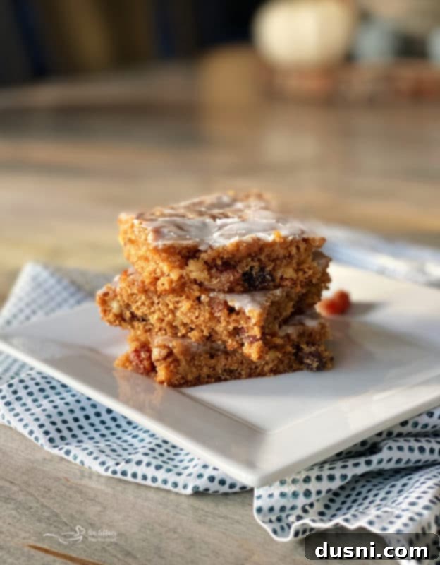 Delicious Iced Raisin Spice Bars with a dusting of cinnamon, sliced and ready to eat.