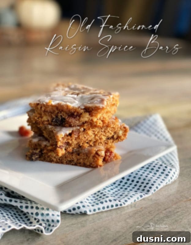 A stunning hero shot of Old Fashioned Raisin Bars, perfectly iced and garnished, inviting viewers to bake.