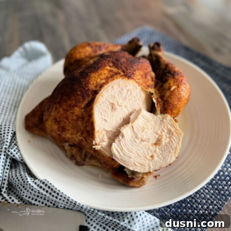 Expertly seasoned whole chicken ready for the slow cooker