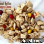 Peanut Butter Muddy Buddies 2 overhead of peanut butter puppy chow spread out on a white cloth