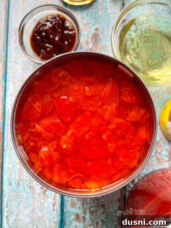 The simmering broth of tortilla soup, rich with tomatoes and spices, promising a comforting meal.