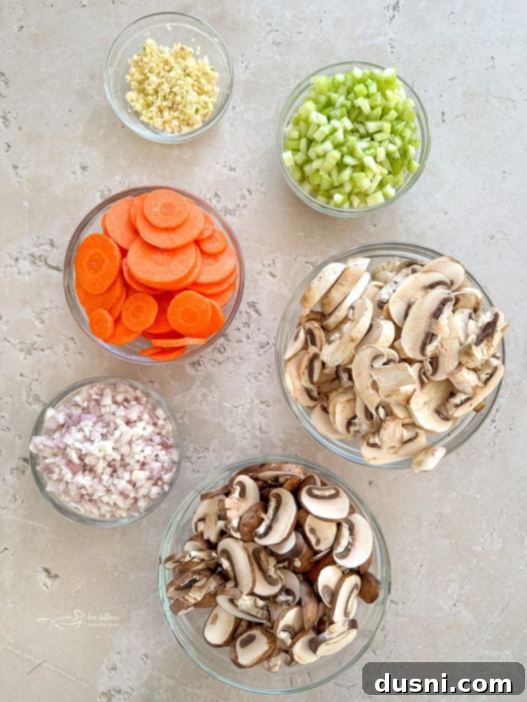Hearty Beef and Mushroom Barley Soup 6 A mix of fresh mushrooms, shallots, garlic, carrots, and celery ready for the Beef Barley Soup.
