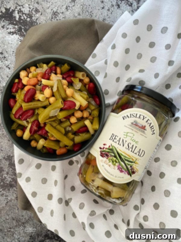 Effortless Wild Rice Stuffed Chicken 4 A jar of Paisley Farm Five Bean Salad next to a serving bowl.