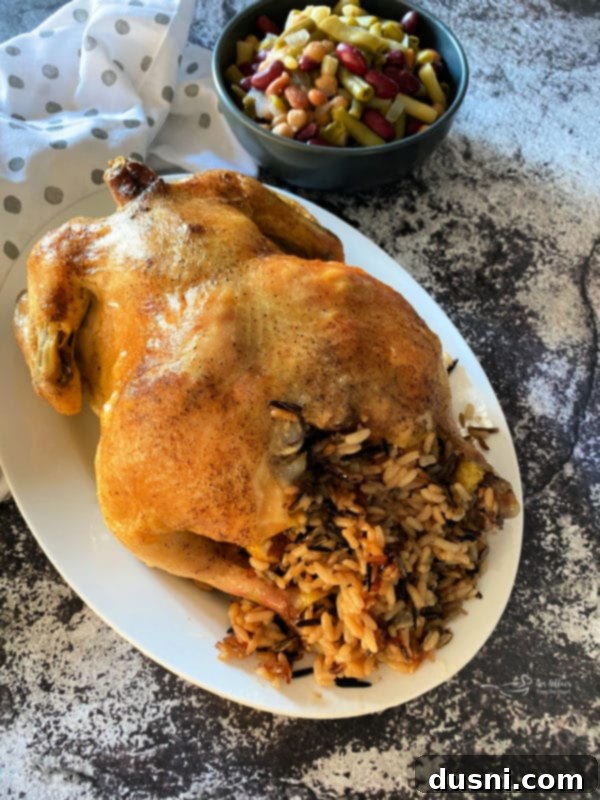 Effortless Wild Rice Stuffed Chicken 7 A whole roasted chicken with wild rice stuffing being served.