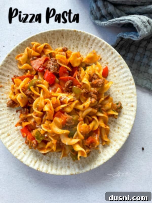 Hero image of baked pizza pasta, golden brown with melted cheese