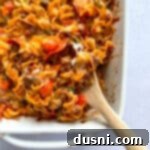 Pizza pasta being scooped out with a wooden spoon