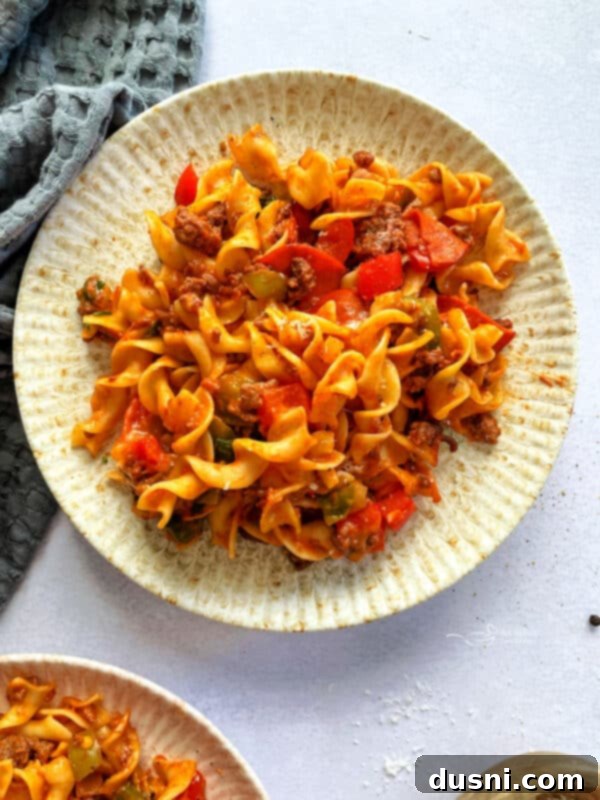 Close-up of a serving of pizza pasta with visible pepperoni and cheese