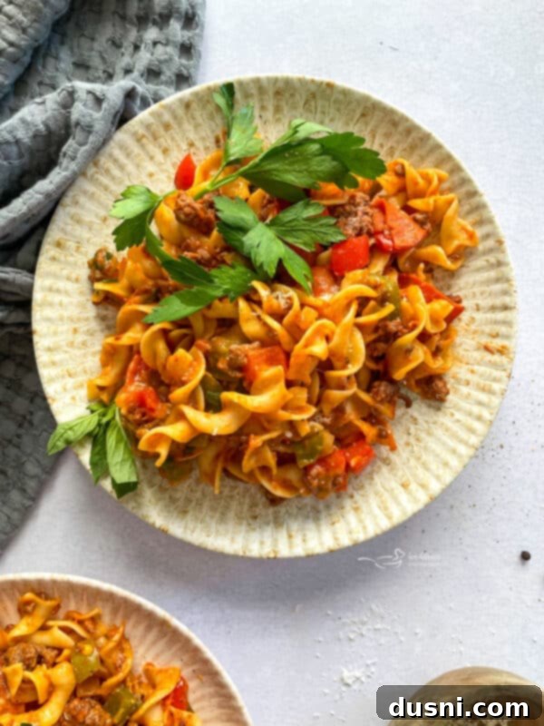 A large baking dish filled with cheesy pizza pasta ready to be served