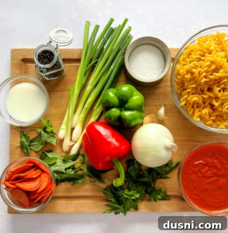 Ingredients for pizza pasta including ground beef, pepperoni, cheese, and pasta