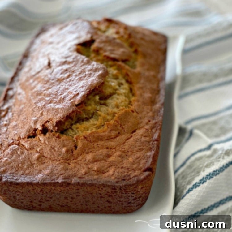 The Ultimate Banana Bread 4 A freshly baked, golden brown loaf of the best banana bread, ready to be sliced