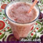 Supercharged Raspberry Peach Delight 2 Overhead view of a glass filled with Raspberry and Peach Superfood Smoothie, ready to drink