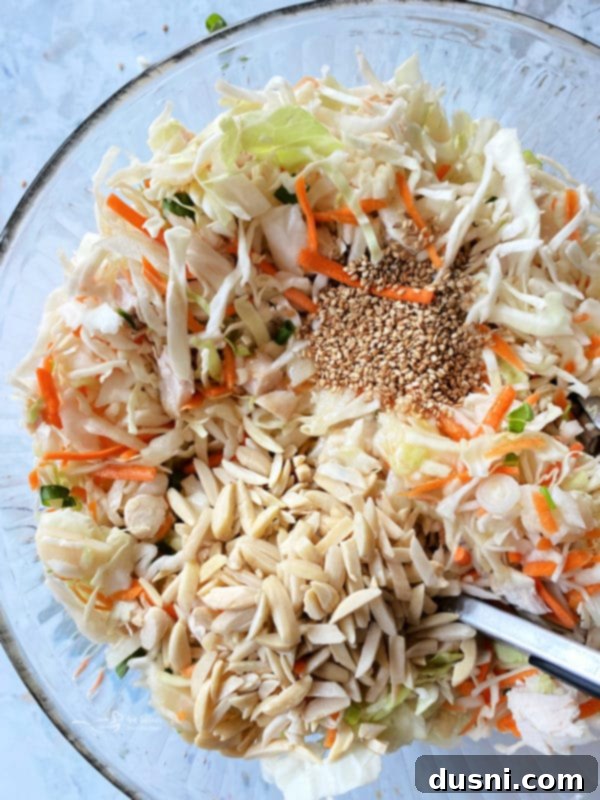 Mixing Chinese Chicken Salad ingredients in a large bowl
