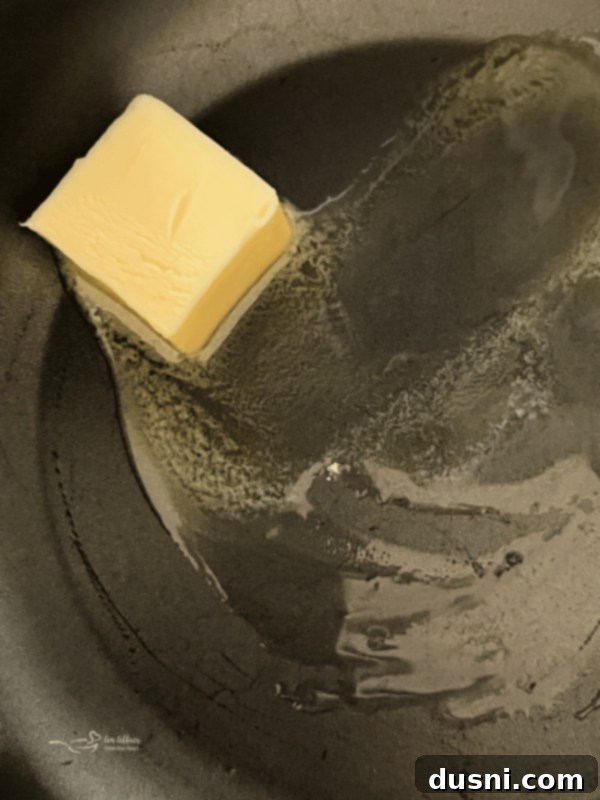 Butter melting in a hot skillet, ready for flour.