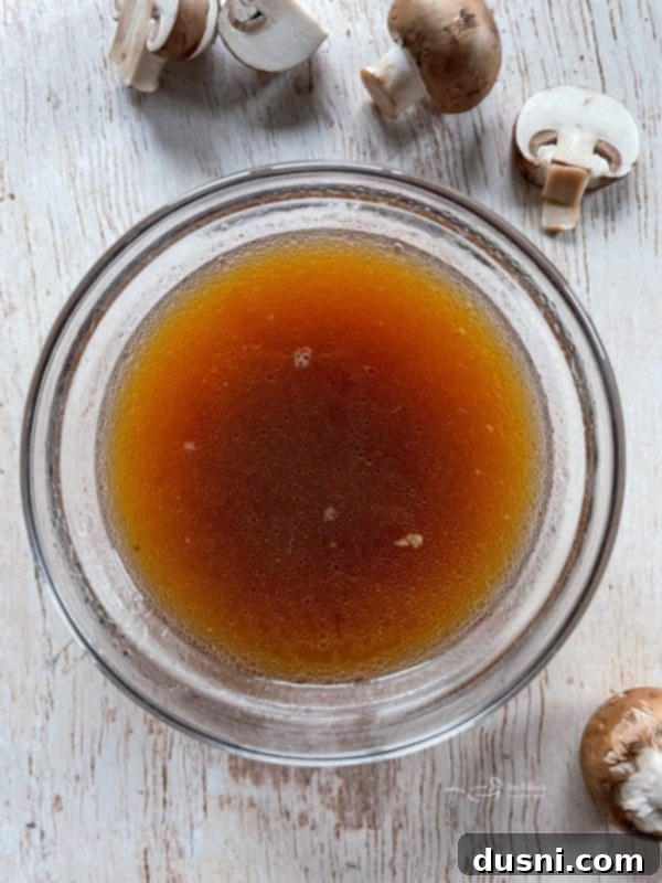 Mouthwatering Crock Pot French Dip Sandwiches 8 Rich au jus broth in a bowl, ready for dipping French dip sandwiches.