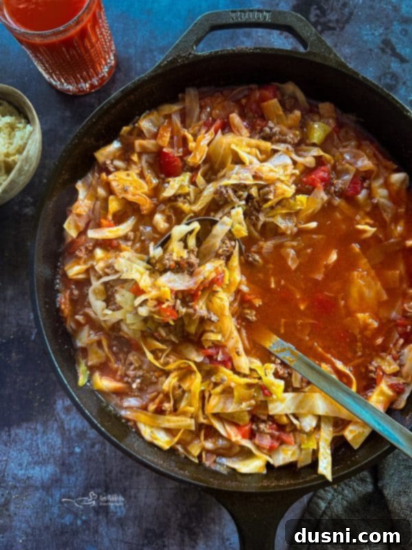 Classic Cabbage Roll Soup Made Two Ways 2 A steaming bowl of hearty Cabbage Roll Soup with a spoon