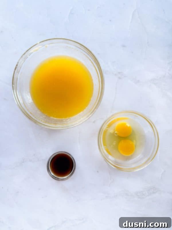 Ingredients for Malted Chocolate Chip Cookies laid out on a table, including flour, chocolate chips, and Ovaltine.