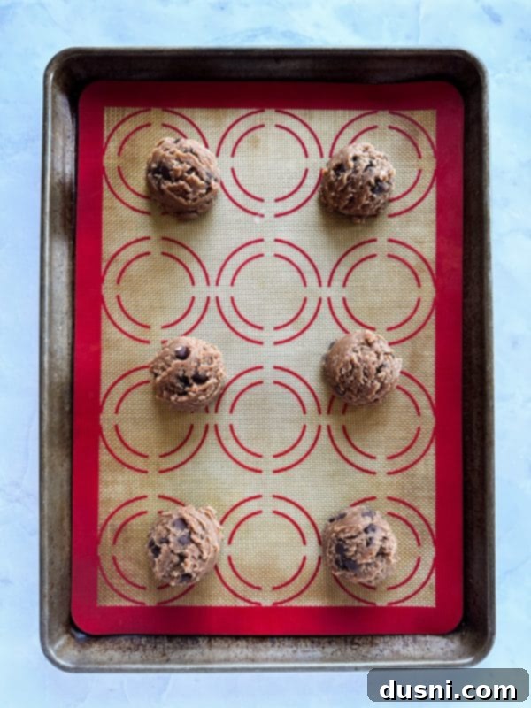 Portioned Malted Chocolate Chip Cookie dough balls, scooped and ready for baking.