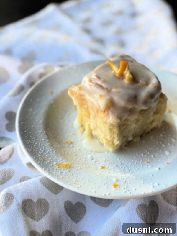 View of lemon sweet roll on white plate.