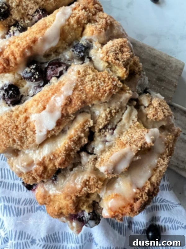 Blueberry Scone Bread generously covered in a luscious lemon glaze.