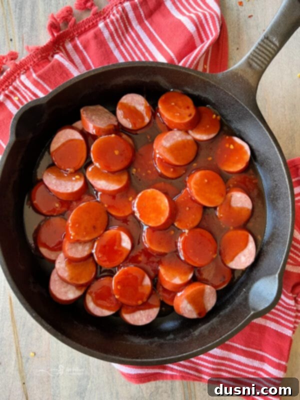 Smoky Sausage & Tangy Kraut Sandwiches 11 Pouring BBQ sauce over sliced sausage