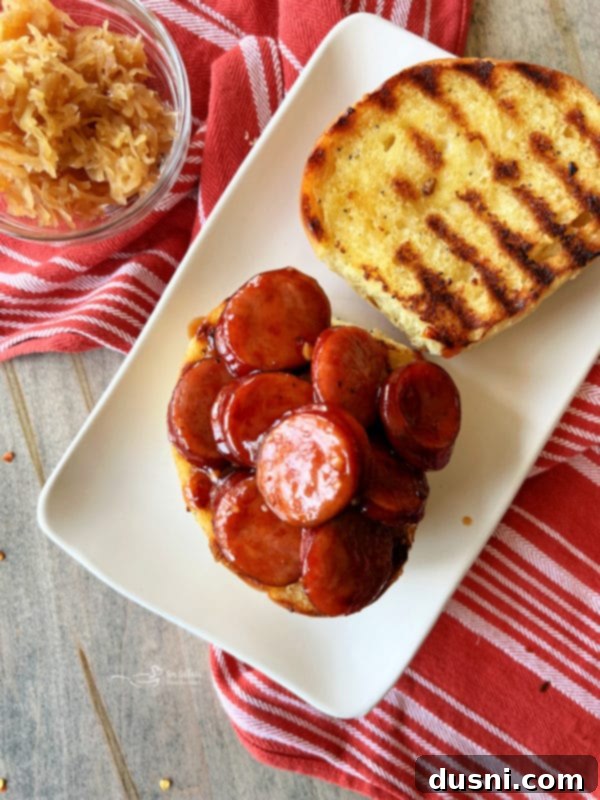 Smoky Sausage & Tangy Kraut Sandwiches 14 Scooping BBQ smoked sausage onto a bun