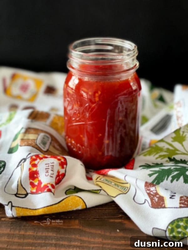 Smoky Sausage & Tangy Kraut Sandwiches 5 Homemade BBQ Sauce in a jar on a multi-colored cloth