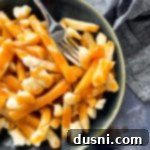 Authentic Homemade Poutine: A Canadian Classic 16 Canadian Poutine in a bowl with a fork