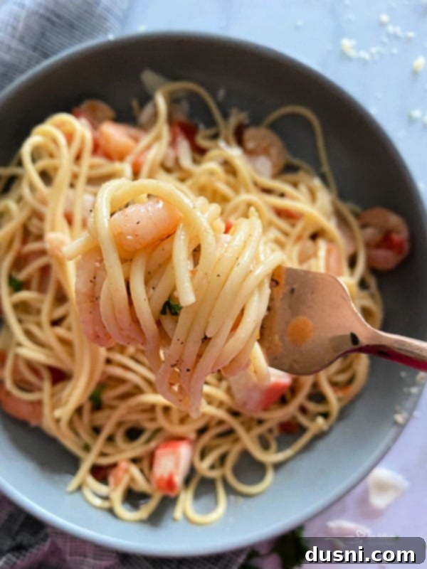 Coastal Crab & Shrimp Pasta 4 Fresh ingredients laid out on a kitchen counter: shrimp, crab meat, tomatoes, garlic, onion, and butter.