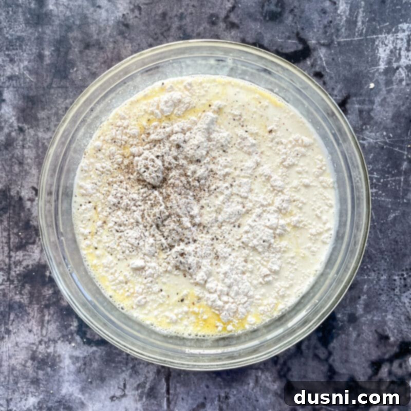 Ham & Cheese Brunch Enchiladas 11 Multiple rolled enchiladas neatly arranged seam-side down in a glass baking dish