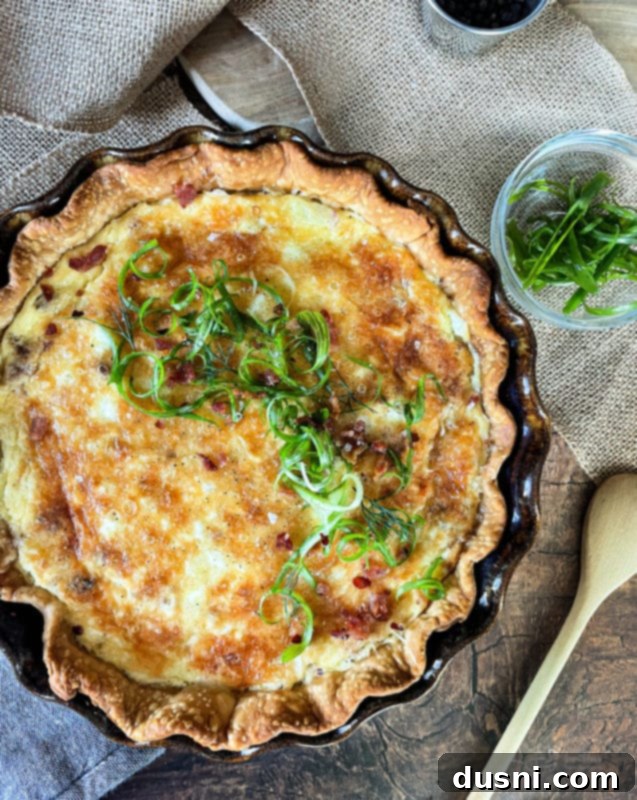 Ham & Cheese Brunch Enchiladas 20 Overhead shot of a delicious Bacon & Swiss Quiche in a pie dish, with a slice removed