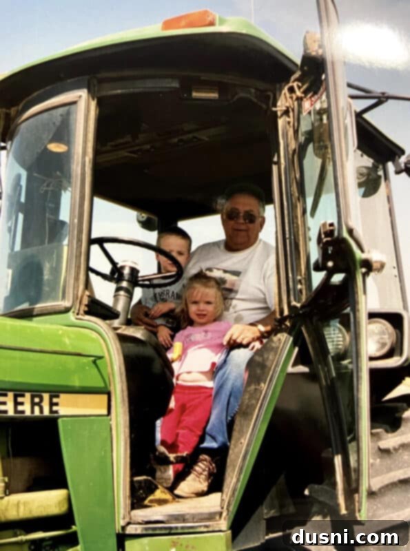Vintage photo of a sprawling Iowa farm with a classic farmhouse, barn, and fields