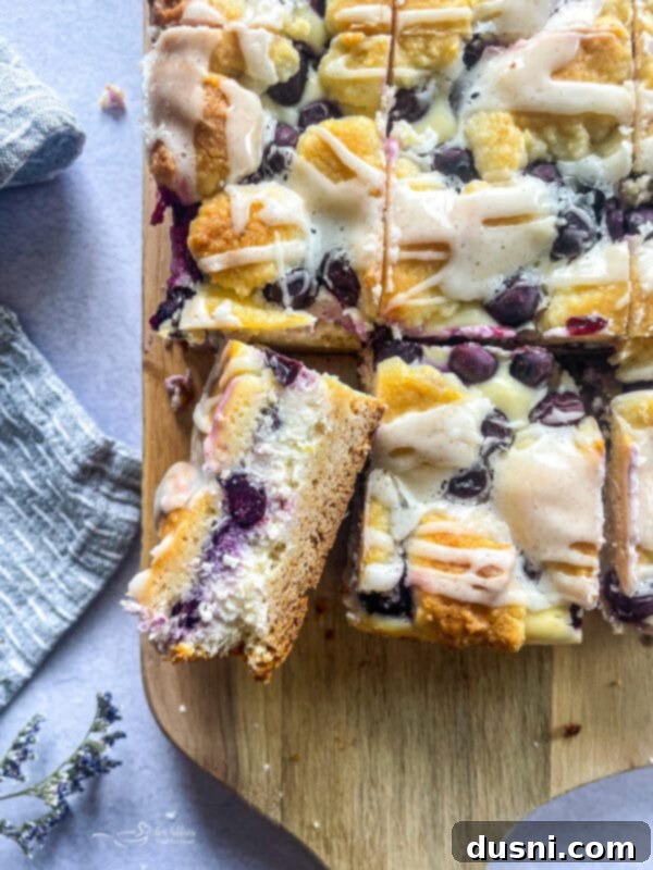 Lemon Blueberry Crumble Bliss 2 slice blueberry lemon crumb bar filled with cheesecake filling