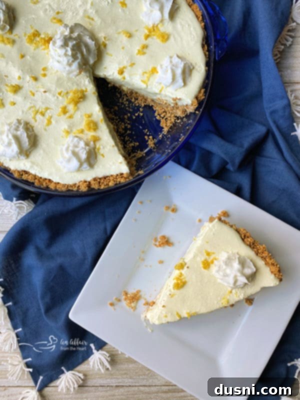 An overhead shot of a whole Lemon Icebox Pie and a single slice on a white plate, highlighting its refreshing look