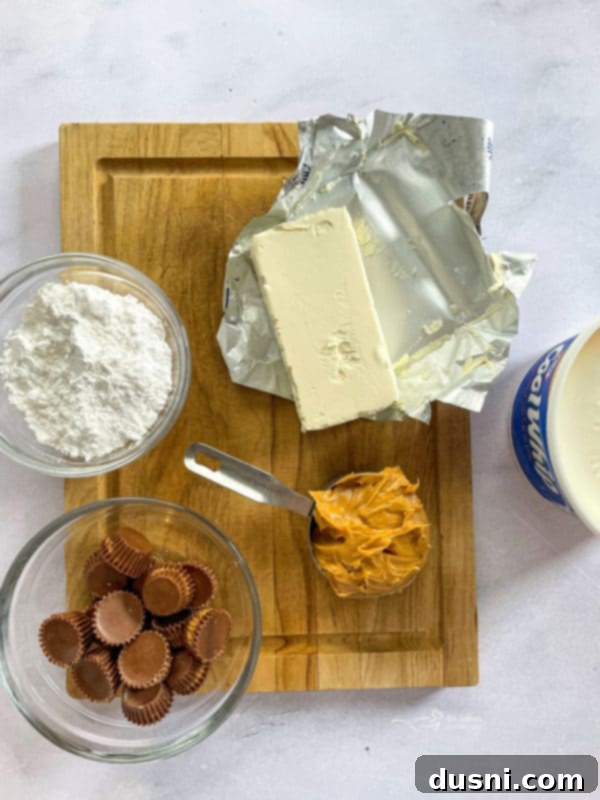 Key ingredients laid out for the creamy no-bake peanut butter pie filling: cream cheese, creamy peanut butter, powdered sugar, and a container of Cool Whip