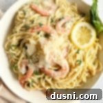 Bright Lemon Basil Creamy Shrimp Pasta 13 Shrimp Pasta in a Bowl with Lemon Slices and Basil