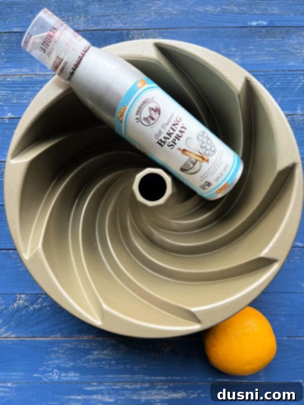 Luscious Lemon Cream Cheese Bundt Cake 8 Preparing a bundt cake pan with non-stick baking spray for lemon cake