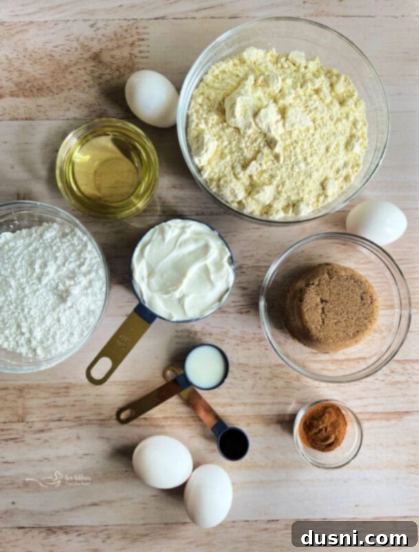 Ingredients laid out for Honey Bun Cake, including yellow cake mix, eggs, oil, sour cream, brown sugar, cinnamon, pecans, powdered sugar, milk, vanilla