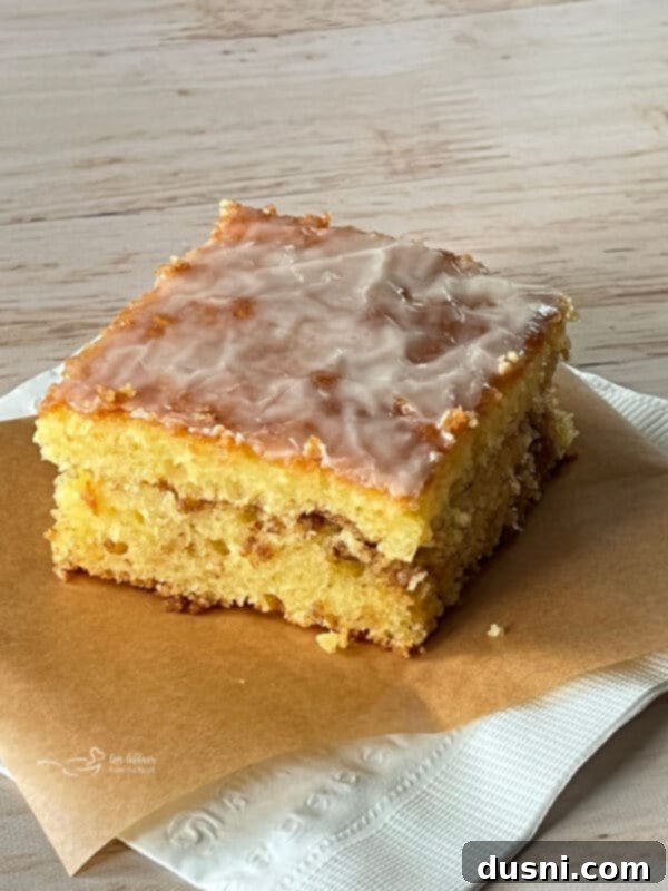 Honey Bun Cake in a square baking dish, resting on napkins