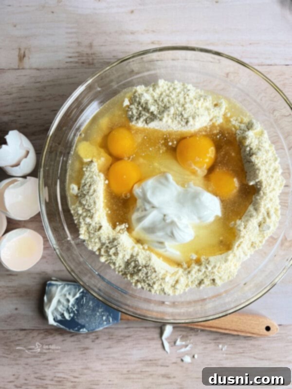 Preparing ingredients for Honey Bun Cake, showing sour cream and eggs