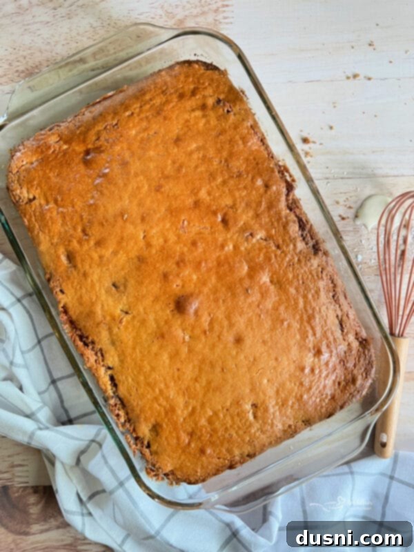 Honey Bun Cake being removed from the oven, golden brown and cooked