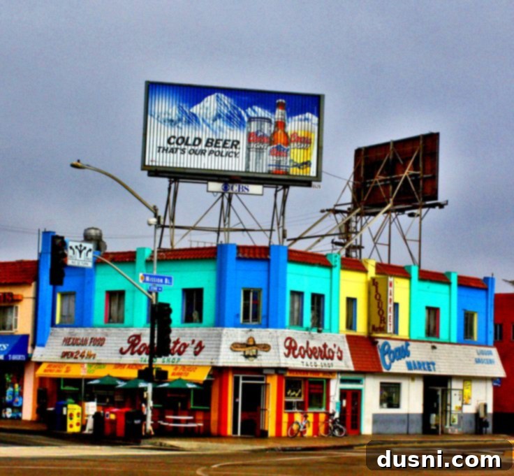 Tender Slow Cooker Pulled Beef Burritos 11 Shredded beef burrito ingredients laid out on a table with a finished burrito in the foreground.