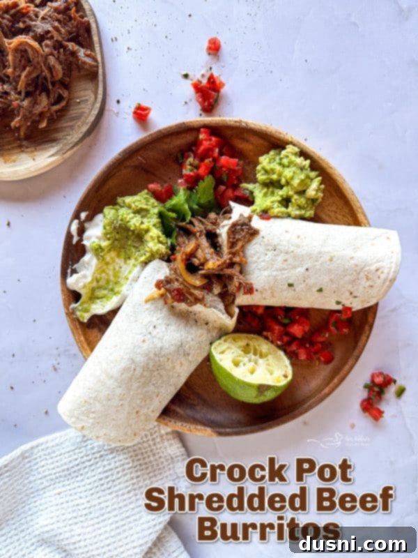Tender Slow Cooker Pulled Beef Burritos 12 Perfectly rolled Crock Pot Shredded Beef Burritos ready to eat, arranged on a plate.