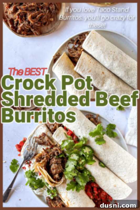 Tender Slow Cooker Pulled Beef Burritos 8 Several Crock Pot Shredded Beef Burritos displayed on a rustic wooden board with a cutting board and a full crock pot in the background.