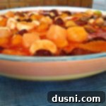 Side view of fruit salad in a multi colored bowl