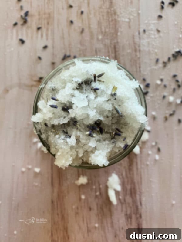 Lavender Shortbread and Lavender Strawberry Cream 24 Overhead shot of a jar of homemade lavender sugar scrub with dried lavender buds and a wooden spoon.