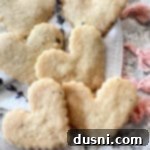 Lavender Shortbread and Lavender Strawberry Cream 26 heart shaped lavender shortbread stacked on a white cloth.